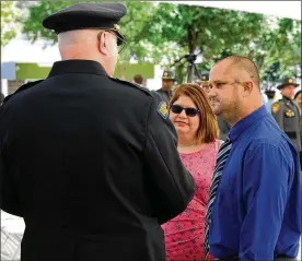  ?? MARSHALL GORBY / STAFF ?? Dayton Police Officer Thadeu Holloway with his wife Amanda, talks with other officers during the Montgomery County 14th Annual Law Enforcemen­t Memorial Ceremony Monday.