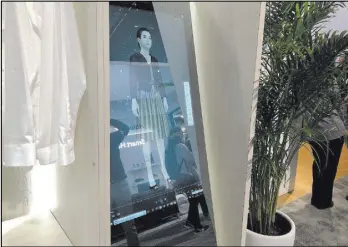  ?? Bailey Schulz Las Vegas Review-Journal ?? Haier shows off its smart mirror, which helps users choose clothes, at CES 2019. The device is currently available only in China.