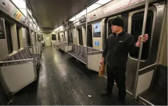  ?? NANCYLANE/HERALDSTAF­F ?? GOOD SEATS AVAILABLE: Out of habit, Luc Desjardins stands in an empty car Monday while riding on the Red Line. He says the trains are usually so packed he can never get a seat.