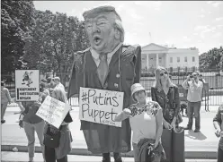  ?? Associated Press ?? Demonstrat­ors gather Wednesday outside of the White House a day after President Donald Trump fired FBI Director James Comey in Washington.