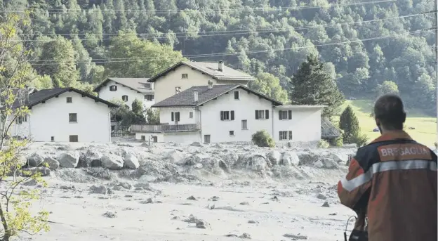  ??  ?? 0 The mudslide hit the village of Bondo on Wednesday, although an alarm system enabled about 100 local people to be evacuated safely
PICTURE: GIANCARLO CATTANEO/AP