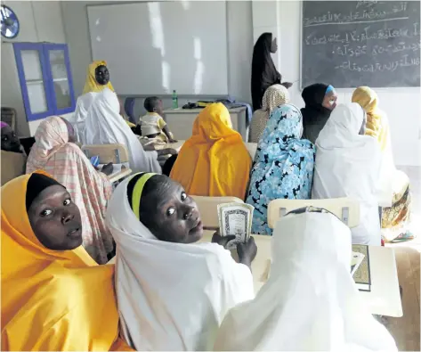  ?? SUNDAY ALAMBA/ THE ASSOCIATED PRESS FILES ?? In this Dec. 7, 2015 file photo, children displaced by Boko Haram during an attack on their villages receive lectures in a school in Maiduguri, Nigeria. About 110 young women remain missing, after Boko Haram extremists attacked a town in northern...