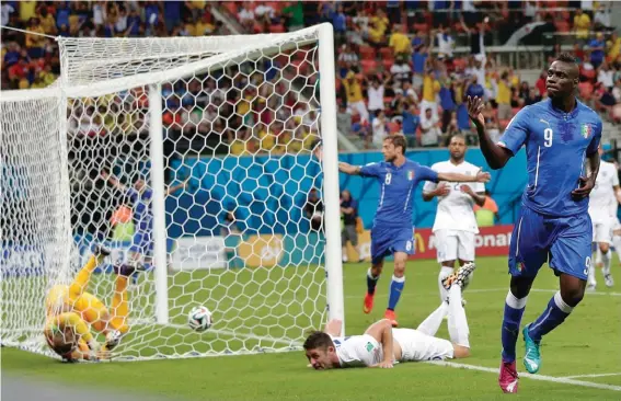  ??  ?? In this Saturday, June 14, 2014 file photo, Italy's Mario Balotelli celebrates after scoring past England's goalkeeper Joe Hart, left, during the group D World Cup soccer match between England and Italy at the Arena da Amazonia in Manaus, Brazil.