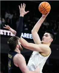  ?? The Associated Press ?? ■ Purdue center Zach Edey, right, shoots over Northweste­rn center Matthew Nicholson during the first half Sunday in Evanston, Ill.