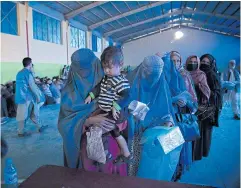  ?? NYT ?? Women wait to register for food aid from the World Food Programme in Kabul.