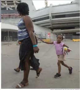  ?? RYAN REMIORZ/THE CANADIAN PRESS ?? Montreal’s Olympic Stadium is being used as temporary housing to deal with the influx of asylum seekers, many of them Haitian, arriving from the U.S.