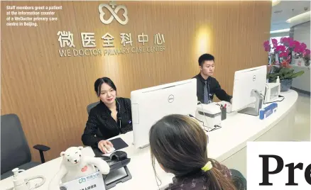  ??  ?? Staff members greet a patient at the informatio­n counter of a WeDoctor primary care centre in Beijing.