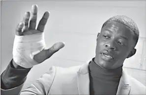  ?? Associated Press ?? ■ James Shaw Jr. shows his hand that was injured when he disarmed a shooter Sunday inside a Waffle House in Nashville, Tenn. A gunman stormed the Waffle House restaurant and shot several people to death before dawn, according to police, who credited...