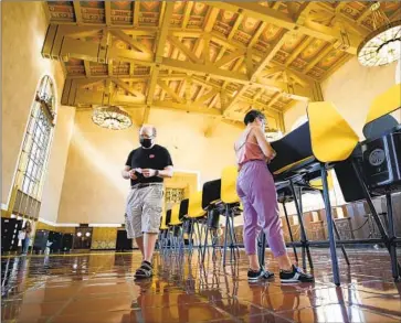  ?? Al Seib Los Angeles Times ?? JOSH HODAS and Serena Delgadillo cast their votes during the gubernator­ial recall election in September at Los Angeles’ Union Station. Tuesday’s primary is expected to have one of the lowest turnouts in state history.