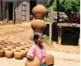  ??  ?? From top left, new Nyein pots dry in the sun while a woman carries smaller pots; with some students shy to see a foreigner for the first time Opposite, clockwise from top left, elephants in the north are used to carry teak logs; two views of teak-carved Shwenandaw Monastery; gold-tipped stupas; rows of Buddha images in Mahamui Pagoda; young monks playing among the wavy terraces of Paya Hsinbyume; interior of Mahamuni Paya, which attracts pilgrams from all over the country Center, Shwesandaw Paya, one of the largest pagodas in Bagan