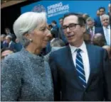  ?? AP PHOTO/JOSE LUIS MAGANA ?? Internatio­nal Monetary Fund (IMF) Managing Director Christine Lagarde speaks with Treasury Secretary Steven Mnuchin on Saturday during the Internatio­nal Monetary Fund IMF Governors group photo at the World Bank/IMF Spring Meetings in Washington.