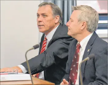  ?? RYAN ROSS/THE GUARDIAN ?? Health Minister Robert Mitchell, left, sits with Agricultur­e Minister Robert Henderson in the legislatur­e Tuesday before announcing plans to avoid further emergency room closures at Kings County Memorial Hospital in Montague.