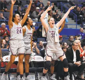  ?? Jessica Hill / Associated Press ?? UConn’s Napheesa Collier (24), Megan Walker (3) and Katie Lou Samuelson (33) celebrate during a Feb. 20 game in Hartford.