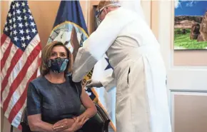  ?? ANNA MONEYMAKER/THE NEW YORK TIMES VIA AP, POOL ?? House Speaker Nancy Pelosi receives a Pfizer-BioNTech COVID-19 vaccine shot on Friday. Congress passed a two-day stopgap spending bill Friday night to avert a partial government shutdown.