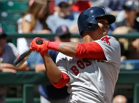  ?? ?? Boston Red Sox’s Rafael Devers follows through after hitting a solo home run, his first major-league hit, in the third inning of a baseball game against the Seattle Mariners, Wednesday, July 26, 2017, in Seattle.