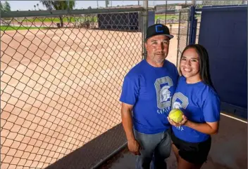  ?? PHOTO VINCENT OSUNA ?? Central Union High’s co-head softball coach Chris Acosta and his daughter, Jessica, pose on Thursday at Emma Jones Field in El Centro.