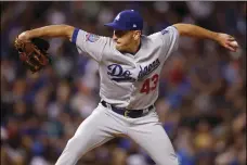  ?? AP PHOTO/DAVID ZALUBOWSKI ?? Los Angeles Dodgers relief pitcher Pat Venditte works as a left-handed pitcher against Colorado Rockies’ Ryan McMahon, a left-handed batter, in the seventh inning of a baseball game on Saturday, in Denver.