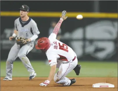  ?? NWA Democrat-Gazette/Andy Shupe ?? SAFE AT SECOND: Arkansas left fielder Jake Arledge rounds second as the ball sails into left field while Oral Roberts second baseman Nick Roark backs up the play in the seventh inning of the Razorbacks’ 3-0 victory Friday night at Baum Stadium in...