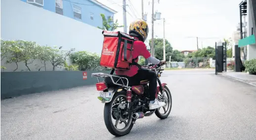  ?? GLADSTONE TAYLOR/MULTIMEDIA PHOTO EDITOR ?? A QuickPlate motorcycli­st exits 80 LMR in St Andrew on Wednesday. The food-delivery outfit has noticed an increase in user registrati­on amid the local spread of COVID-19 in Jamaica and intends to launch a grocery-delivery offering early next week.