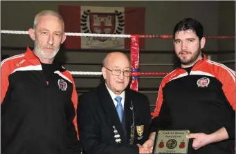  ??  ?? Tim O’Sullivan, President of the Cork Ex Boxers Associatio­n presenting their plaque to Tommy O’Donnell, coach with fellow coach and club chairman Brendan O’Donovan in recognitio­n of the Charlevill­e club being the most successful in County and Cork City...