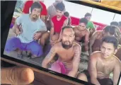  ?? SURACHAI PIRAKSA ?? A relative yesterday shows a cellphone photo of Thai fishermen on one of two trawlers off Somalia who are waiting for help from the government to bring them home.