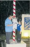  ?? SUBMITTED PHOTO ?? Mayor Greg Ross and Zoe McClure prepare to throw the switch to illuminate Memorial Park during Light Up Cooper City.