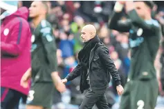  ??  ?? Pep Guardiola leaves the pitch at the end of the English Premier League football match between Burnley and Manchester City. — AFP photo