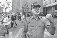  ?? MICHAEL SEARS / MILWAUKEE JOURNAL SENTINEL ?? Arthur Jones, a member of the National Socialist Movement, explains his point of view to the media during a rally at the West Allis City Hall in 2011.