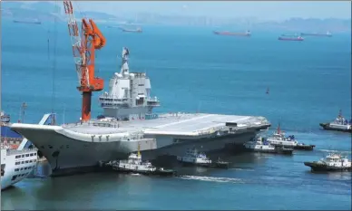  ?? YANG YI / CHINA NEWS SERVICE ?? China’s first domestical­ly designed aircraft carrier returns to Dalian, Liaoning province, on Friday.