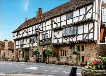  ?? ?? AN OLD FAVOURITE: Timbered exterior, left, of the George. Above:
One of the bedrooms with antique furniture