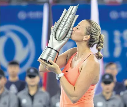  ??  ?? Petra Kvitova of the Czech Republic kisses the trophy after winning the WTA Wuhan Open.