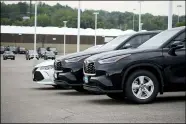  ?? DAVID ZALUBOWSKI — THE ASSOCIATED PRESS FILE ?? A pair of unsold 2021Highla­nder sports utility vehicles and a Camry sedan are parked on the empty storage lot outside a Toyota dealership in Englewood, Colo.