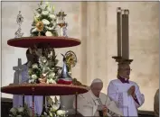  ?? GREGORIO BORGIA — THE ASSOCIATED PRESS ?? Pope Francis sits by the relics of 10 new saints on the altar in St. Peter's Square at The Vatican on Sunday.