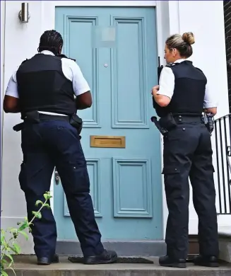  ??  ?? ’Ello, ’ello, ’ello: Police knock Dominic Cummings’s front door yesterday