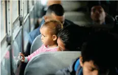  ?? | REUTERS ?? A MIGRANT, part of a convoy of thousands of Central Americans trying to reach the US, looks from the bus window after leaving a camp on Wednesday.