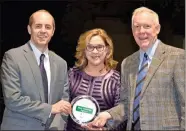  ?? / Gordon County Chamber of Commerce ?? Kathy Johnson, the president and CEO of the Gordon County Chamber of Commerce, stands between Robert Mathews (left) and Jim Mathews (right) as Starr-Mathews Insurance accepts its Legacy Award.