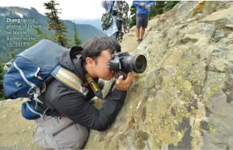  ??  ?? Zhang taking photos of lichen on Mount Rainier in the US, 2017