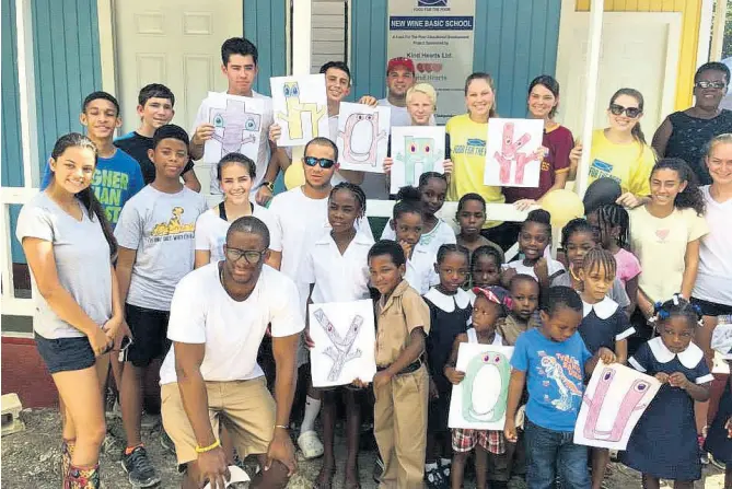  ?? CONTRIBUTE­D ?? Members of the community and school body say thanks to Kind Hearts Foundation after completion of the New Wine Basic School.