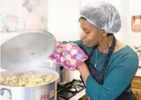  ??  ?? Glenda Andrew prepares West Indian meals with members of the Preston Windrush Covid Response team last month at the Xaverian Sanctuary in Preston, England.