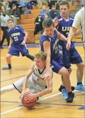  ?? Scott Herpst ?? Oakwood Christian’s Andrew Phillips dives to recover a loose ball during the Eagles’ home game with Shenandoah Baptist last week.