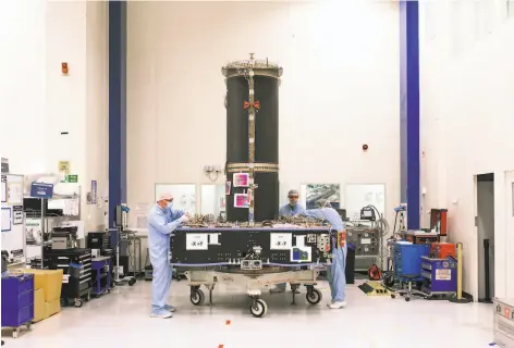  ?? Photos by Francesca Jones / New York Times ?? Workers assemble a module for a telecommun­ications satellite at the Airbus factory in Stevenage, England.