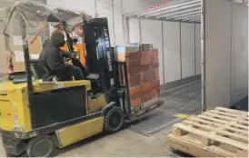  ?? TOM SCHUBA/SUN-TIMES ?? A worker at World Vision’s warehouse in the South Austin neighborho­od loads a semitruck with relief supplies on Sunday.