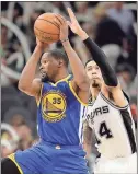  ?? Eric Gay / The Associated Press ?? Golden State forward Kevin Durant (35) controls the ball in front of San Antonio’s Danny Green during the second half of Monday’s game.