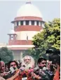  ?? PHOTO: PTI ?? Mahant Dharam Dass of Nirwani Akhara with the media outside SC on Monday. In 2010, the Allahabad HC ruled that the disputed land in Ayodhya be divided into three parts — the Sunni Waqf Board, the Nirmohi Akhara and Ram Lalla