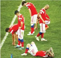  ?? AFP ?? Russian players react at the end of the penalty shootouts, which ended in Croatia’s favour in Sochi on Saturday. —