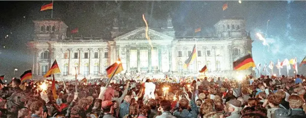  ?? FOTO: JÖRG SCHMITT / DPA ?? Jubelnde Menschenma­ssen vor dem Berliner Reichstag am 3. Oktober 1990: Die Einheit Deutschlan­ds musste zuvor außenpolit­isch verhandelt werden.