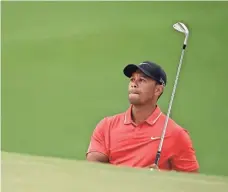  ?? MICHAEL MADRID, USA TODAY SPORTS ?? Four-time champ Tiger Woods hits out of a bunker at Augusta in 2015, his only Masters appearance in the last three years.