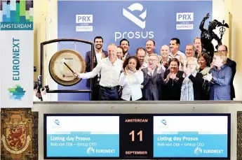  ?? | Reuters ?? NASPERS and Prosus chief executive Bob van Dijk rings a gong to mark Prosus’s debut on the Amsterdam Stock Exchange yesterday. Prosus shares rose as much as 32 percent.