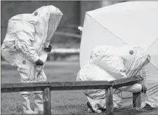  ?? AP PHOTO ?? Personnel in hazmat suits work to secure a tent covering a bench in the Maltings shopping centre in Salisbury, England on Thursday March 8, 2018, where former Russian double agent Sergei Skripal and his daughter Yulia were found critically ill by...