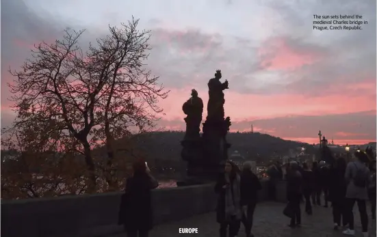  ?? PETR DAVID JOSEK AP file ?? The sun sets behind the medieval Charles bridge in Prague, Czech Republic.